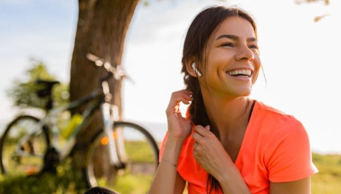 Mulher sorridente perto de uma bicicleta